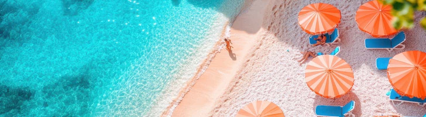 Golden sandy beach with sun loungers & umbrellas
