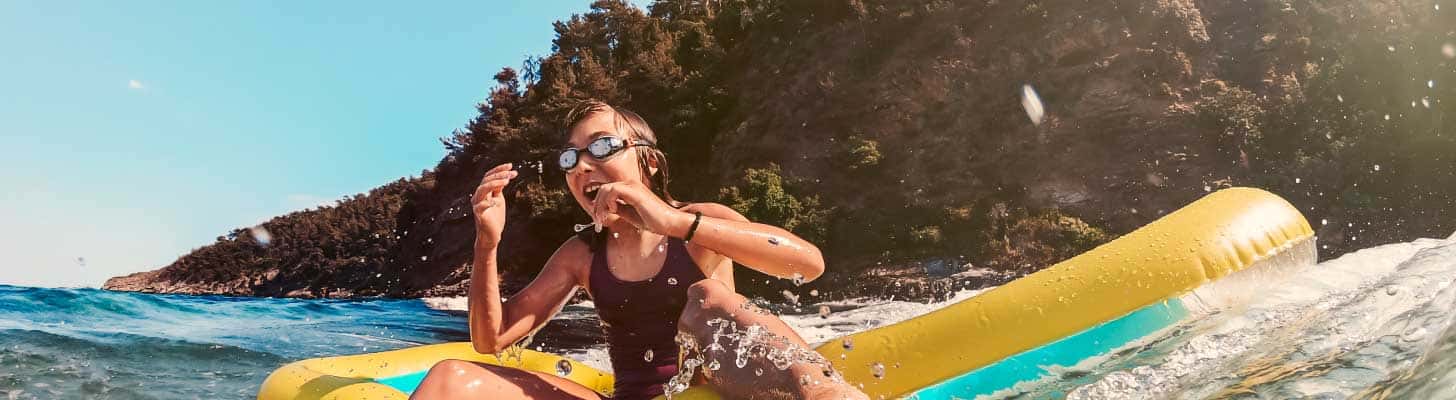 Girl in sea on inflatable