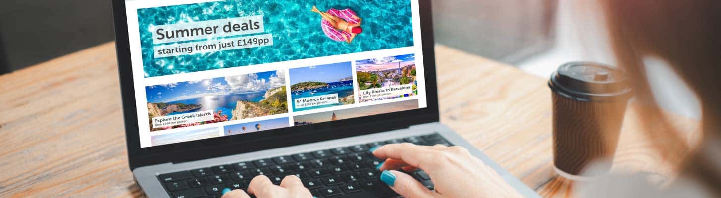 Woman looking at travel website on laptop