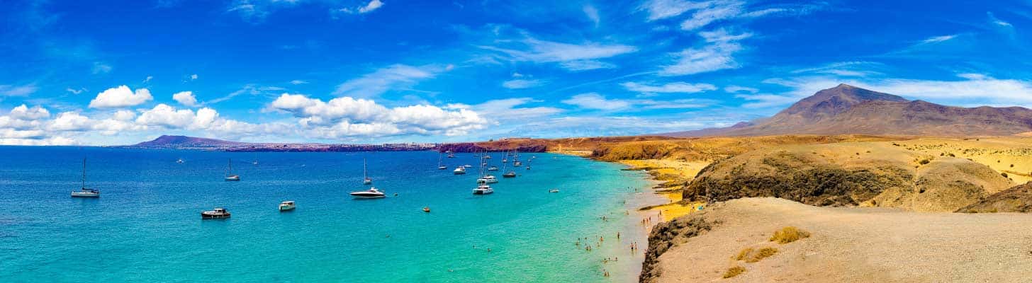 Boats in the blue sea at Playa Blanca in Lanzarote