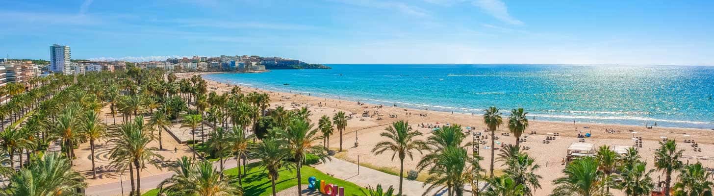Palm trees lining the golden sandy beaches of Salou in Costa Dorada