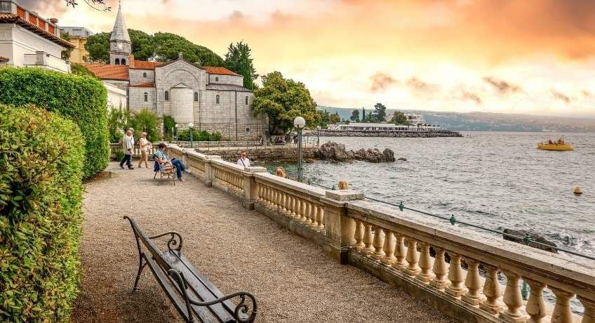 Bench with views overlooking a lake and a stone balcony