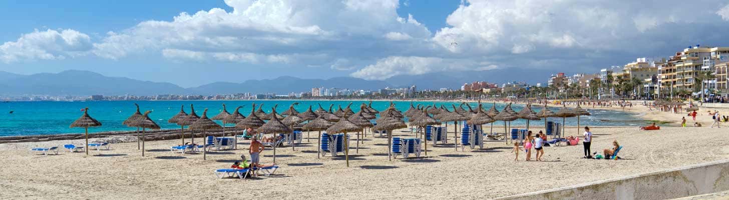 Sun umbrellas & loungers on the sandy beach of El Arenal, Majorca