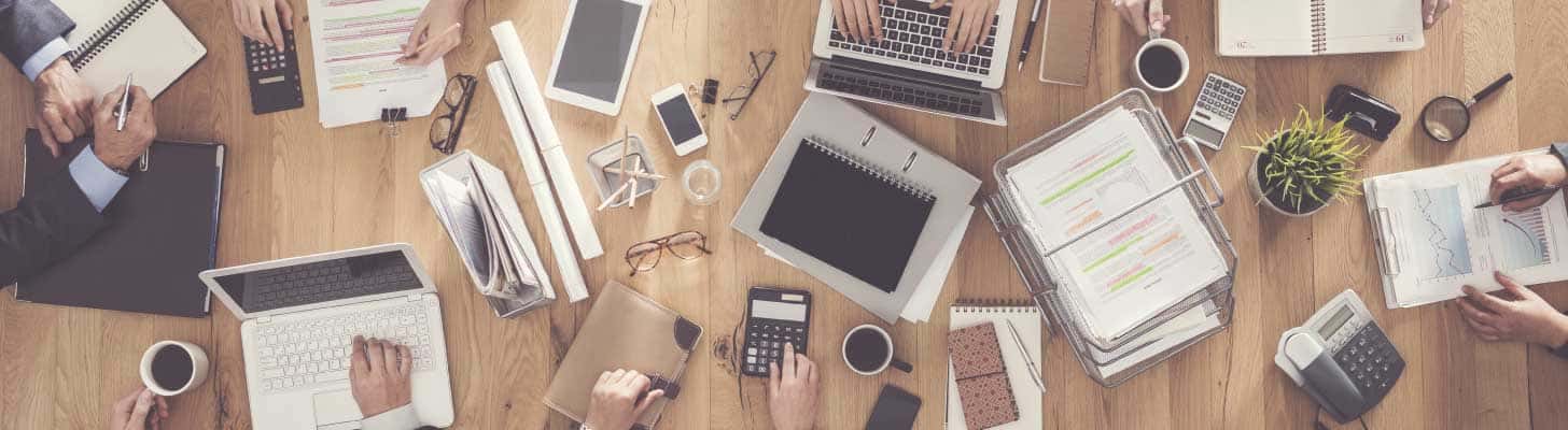Laptops and other work items on a shared office desk