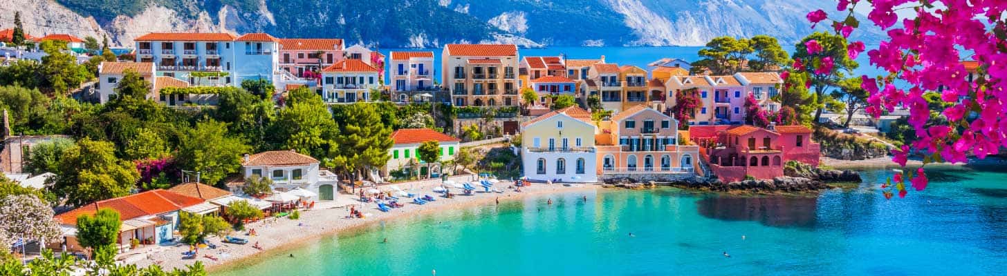 Colourful houses lining the beach in Greece