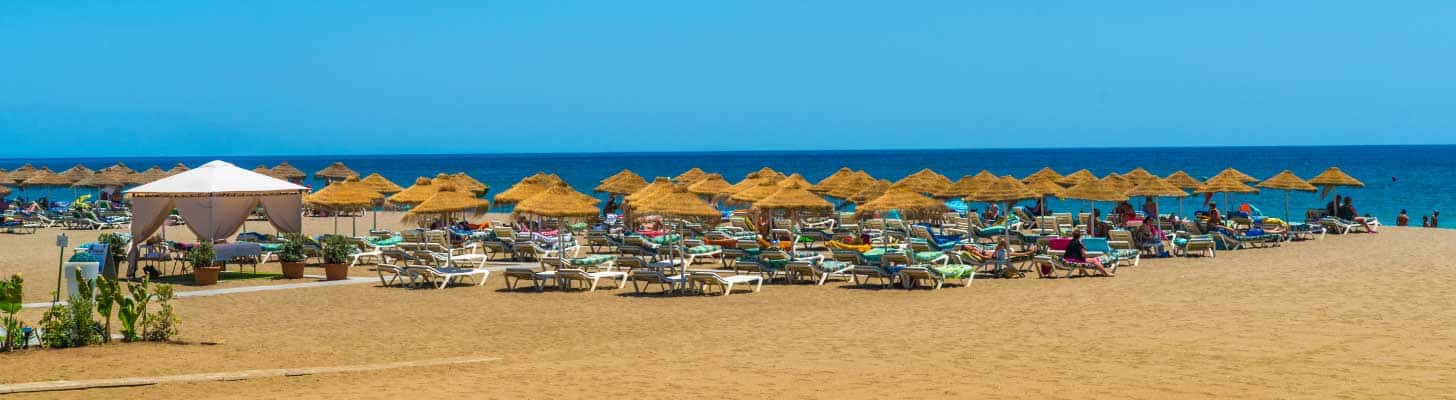 Sunbeds & umbrellas on the sands of a beach in Benalmadena, Costa del Sol