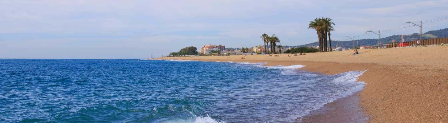 Golden sands & blue sea of a beach in Santa Susanna, Costa Brava