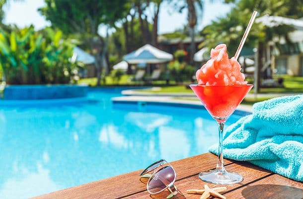 Cocktail & sunglassses by the pool